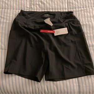 Baleaf black swim shorts. NEVER WORN, STILL HAS TAGS.